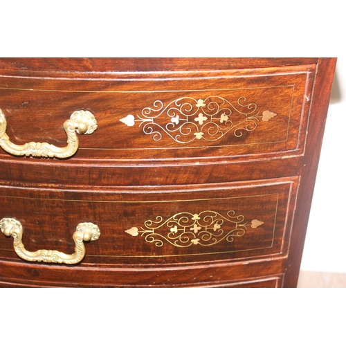 23 - A small vintage Indian style carved 4 drawer chest of drawers with brass inlay and fittings, approx ... 