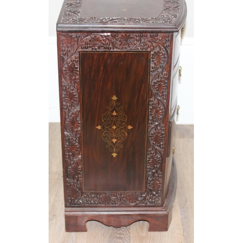 23 - A small vintage Indian style carved 4 drawer chest of drawers with brass inlay and fittings, approx ... 