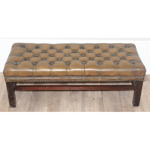 26 - A Victorian Revival Chesterfield style ottoman or footrest of rectangular form upholstered in tan bu... 