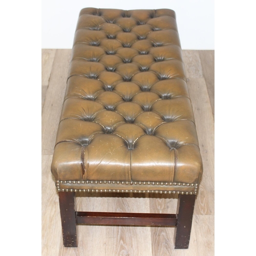 26 - A Victorian Revival Chesterfield style ottoman or footrest of rectangular form upholstered in tan bu... 