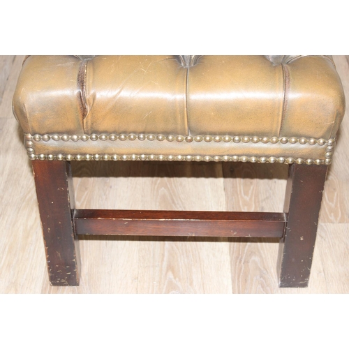 26 - A Victorian Revival Chesterfield style ottoman or footrest of rectangular form upholstered in tan bu... 