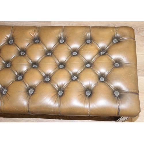 26 - A Victorian Revival Chesterfield style ottoman or footrest of rectangular form upholstered in tan bu... 