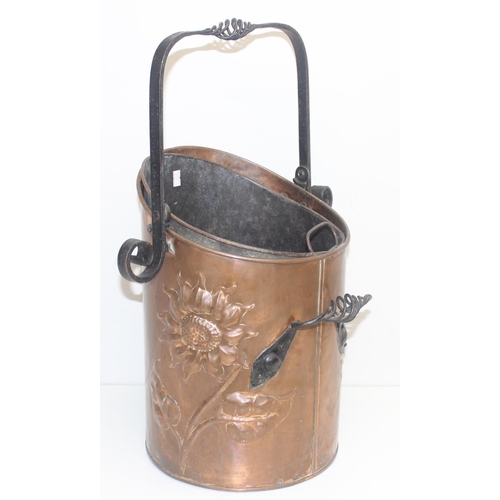 270 - An Arts & Crafts period hammered copper coal scuttle with twisted wrought iron fittings, the copper ... 