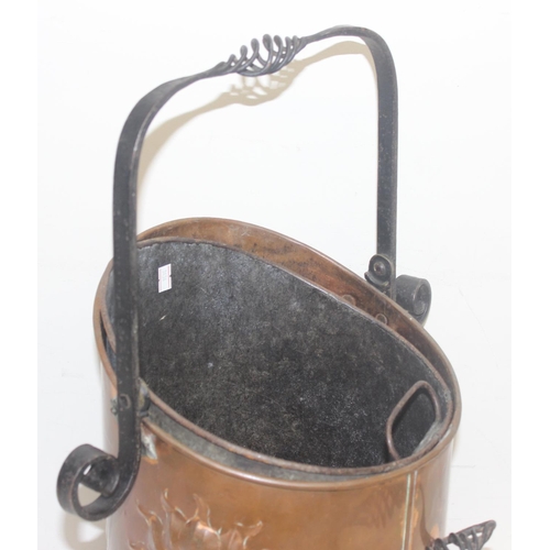 270 - An Arts & Crafts period hammered copper coal scuttle with twisted wrought iron fittings, the copper ... 