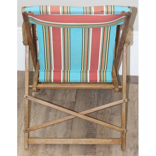 300 - 2 vintage wooden folding deck chairs with colourful fabric, largest approx 110cm tall