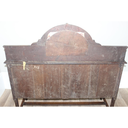 32 - An early 20th century oak sideboard with 2 drawers over a deep central drawer flanked by 2 doors, wi... 