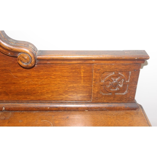 32 - An early 20th century oak sideboard with 2 drawers over a deep central drawer flanked by 2 doors, wi... 