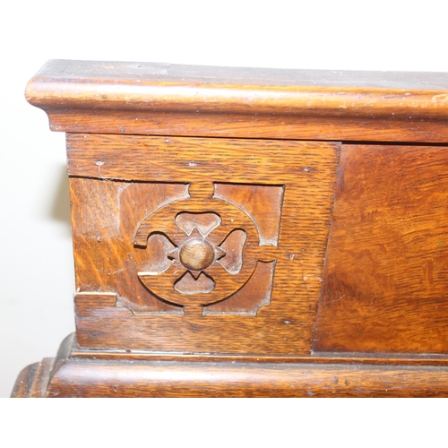 32 - An early 20th century oak sideboard with 2 drawers over a deep central drawer flanked by 2 doors, wi... 