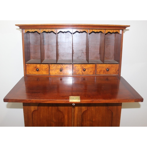 34 - A very unusual Mahogany cupboard or standing clerks desk, the top with drop down front concealing 6 ... 