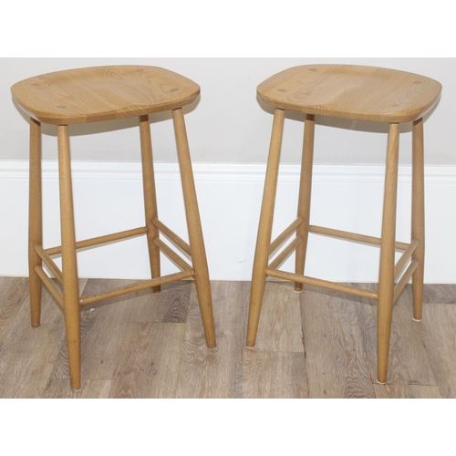 38 - A pair of Ercol kitchen counter or bar stools, blonde finish, with labels under, each approx 39cm wi... 