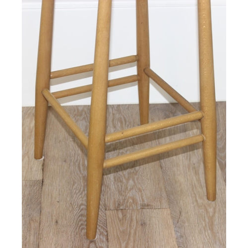 38 - A pair of Ercol kitchen counter or bar stools, blonde finish, with labels under, each approx 39cm wi... 