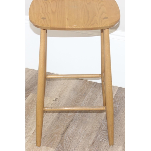 38 - A pair of Ercol kitchen counter or bar stools, blonde finish, with labels under, each approx 39cm wi... 