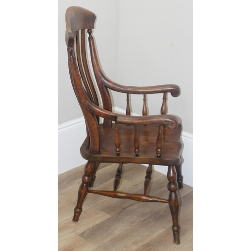 43 - An antique Windsor farmhouse armchair with decorative wheel back slat, approx 120cm tall