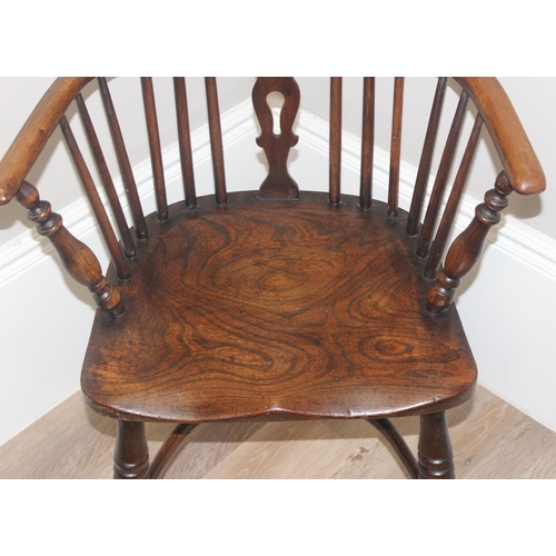 47 - An antique farmhouse horseshoe armchair with hoop back and oak or elm seat, approx 91cm tall