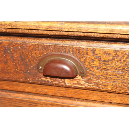 57 - An early 20th century oak desk with 9 drawers with brass cup handles, approx 130cm wide x 63cm deep ... 