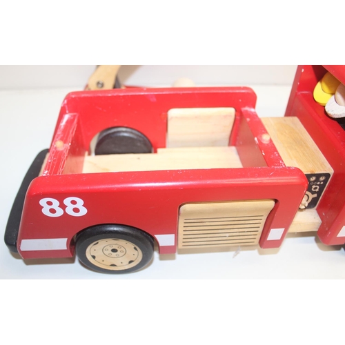 601 - An interesting vintage scratch built wooden model of a London bus with passengers and a wooden toy f... 