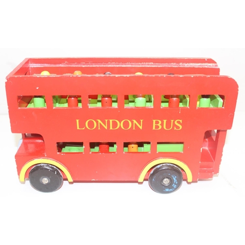 601 - An interesting vintage scratch built wooden model of a London bus with passengers and a wooden toy f... 