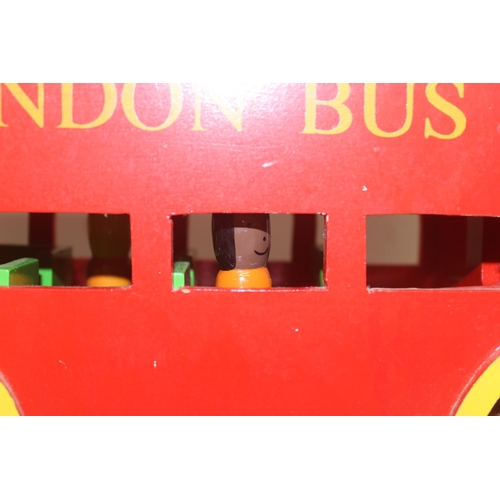 601 - An interesting vintage scratch built wooden model of a London bus with passengers and a wooden toy f... 