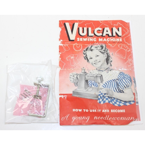 602 - A vintage miniature Vulcan sewing machine with instructions and accessories etc