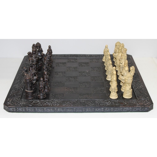 605 - Large vintage resin chessboard and chess set, the board decorated with birds and flowers, king piece... 