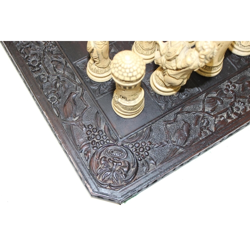 605 - Large vintage resin chessboard and chess set, the board decorated with birds and flowers, king piece... 