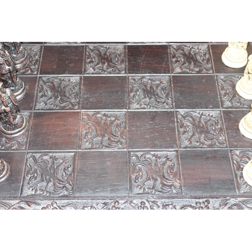 605 - Large vintage resin chessboard and chess set, the board decorated with birds and flowers, king piece... 