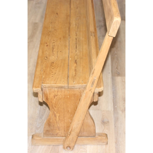 65 - A very unusual metamorphic pitch pine bench or pew with movable back allowing it to be sat one side ... 