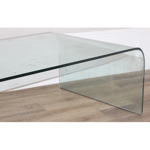 9 - A retro style shaped glass coffee table by Fiam of Italy, etched mark, approx 130cm wide x 70cm deep... 