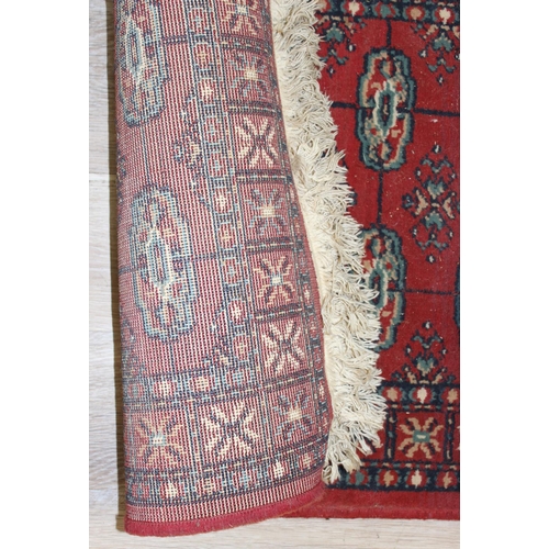 207 - 2 modern rugs, one red and the other a blue hall runner, the runner approx 240cm x 61cm