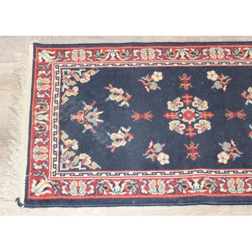 207 - 2 modern rugs, one red and the other a blue hall runner, the runner approx 240cm x 61cm