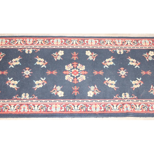 207 - 2 modern rugs, one red and the other a blue hall runner, the runner approx 240cm x 61cm