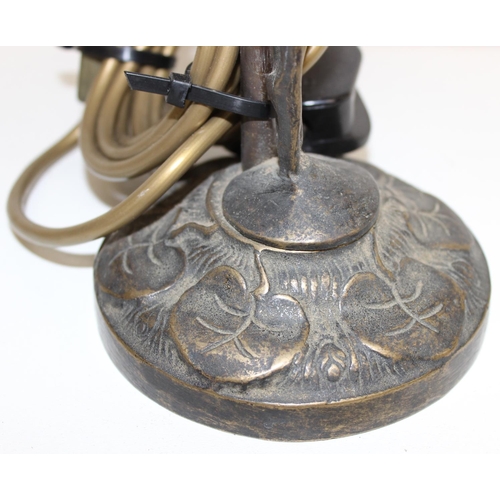 239 - An Art Nouveau style bronze table lamp formed as a nude female standing upon lily-pads with an opaqu... 