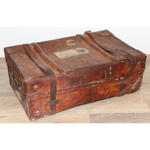 273 - 2 vintage suitcases with a large number of vintage luggage labels, the smaller case leather, the lar... 