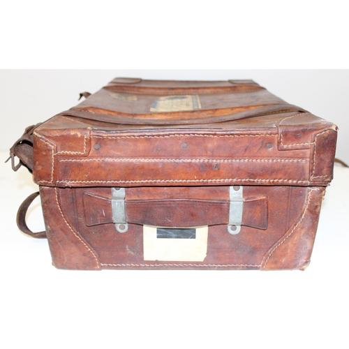 273 - 2 vintage suitcases with a large number of vintage luggage labels, the smaller case leather, the lar... 