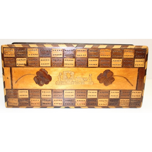 277 - An unusual early 20th century games box, the top formed as a double cribbage board with other marque... 