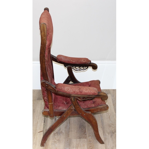 77 - An antique mahogany framed folding campaign chair with red patterned upholstery, likely c.1900, appr... 