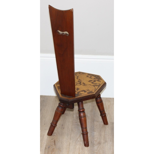 80 - An antique wooden spinning chair with pokerwork lion decoration, approx 87cm tall