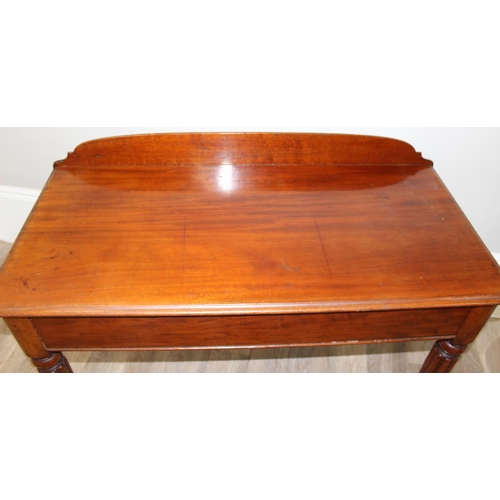 82 - A Victorian mahogany desk, hall table or buffet stand with hidden frieze drawer and reeded legs, app... 