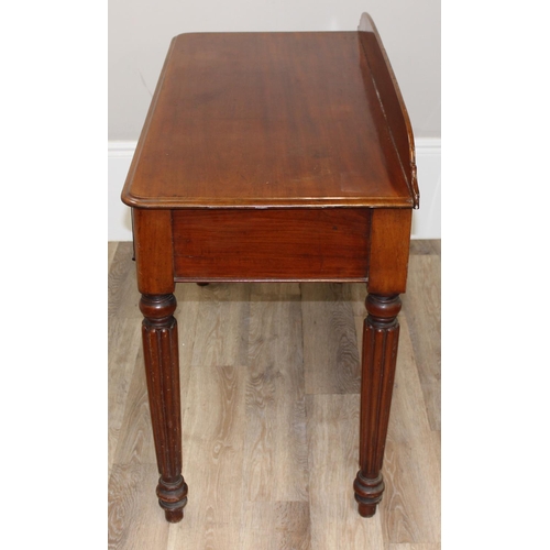 82 - A Victorian mahogany desk, hall table or buffet stand with hidden frieze drawer and reeded legs, app... 