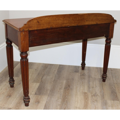 82 - A Victorian mahogany desk, hall table or buffet stand with hidden frieze drawer and reeded legs, app... 