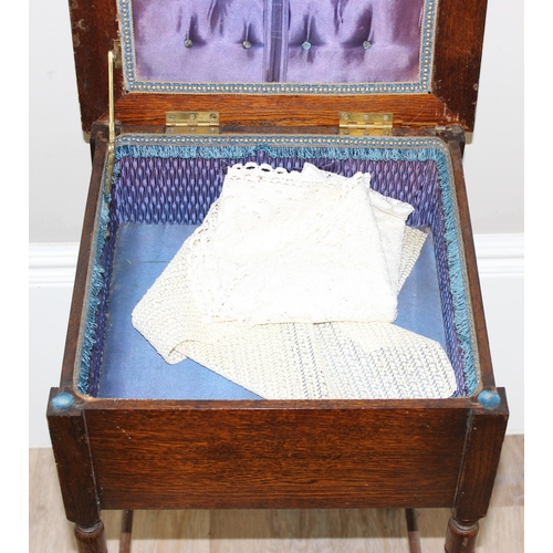 89 - A vintage oak sewing box on legs with some contents and a vintage wooden framed firescreen with Linc... 