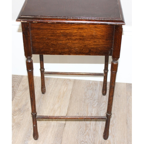 89 - A vintage oak sewing box on legs with some contents and a vintage wooden framed firescreen with Linc... 