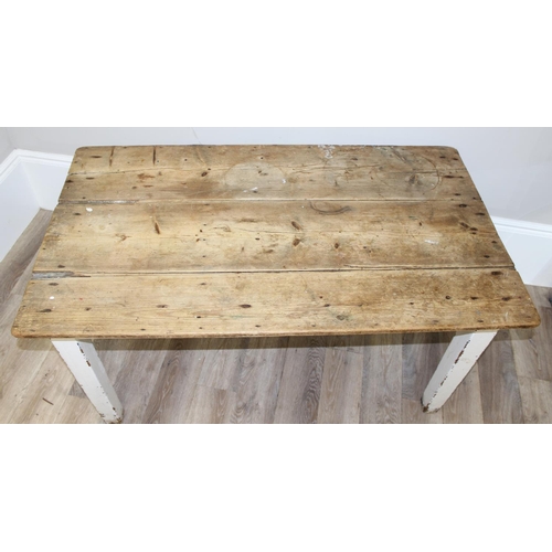 91 - An antique pine rustic farmhouse table with painted base, approx 132cm wide x 74cm deep x 70cm tall