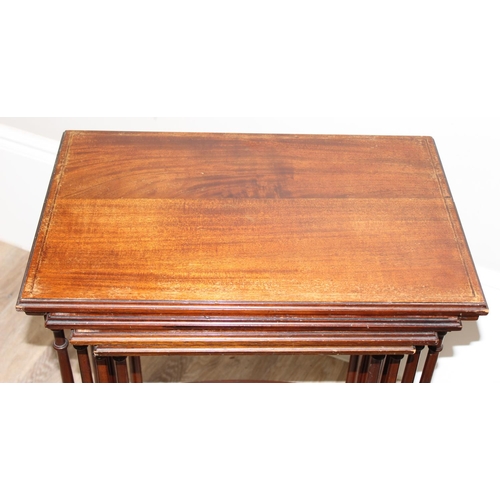 94 - An Edwardian style mahogany nest of 4 tables with turned legs, the largest approx 56cm wide x 35cm d... 