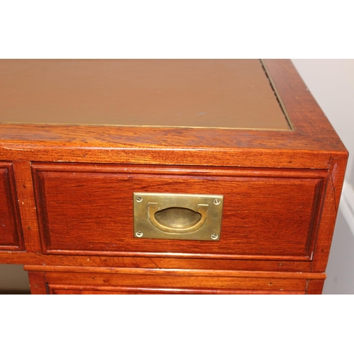 95 - A 20th century Oriental hardwood desk with brass campaign style handles and brown inset leather top,... 