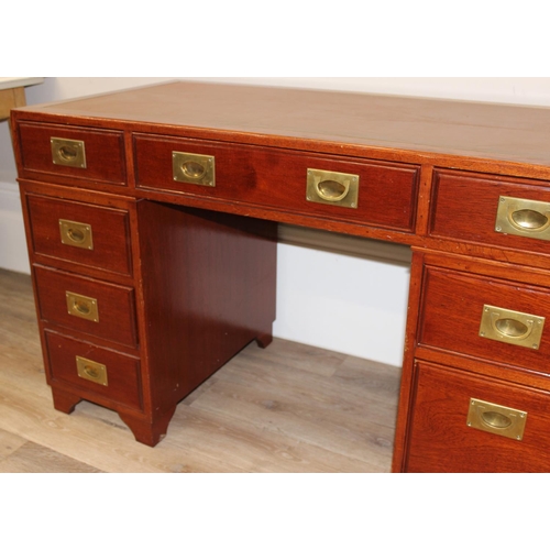 95 - A 20th century Oriental hardwood desk with brass campaign style handles and brown inset leather top,... 