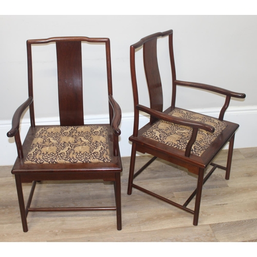 112 - A set of 10 (8 + 2 carvers) Chinese hardwood dining chairs with later animal fabric seats, each appr... 