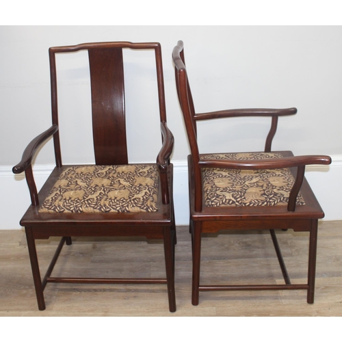 112 - A set of 10 (8 + 2 carvers) Chinese hardwood dining chairs with later animal fabric seats, each appr... 