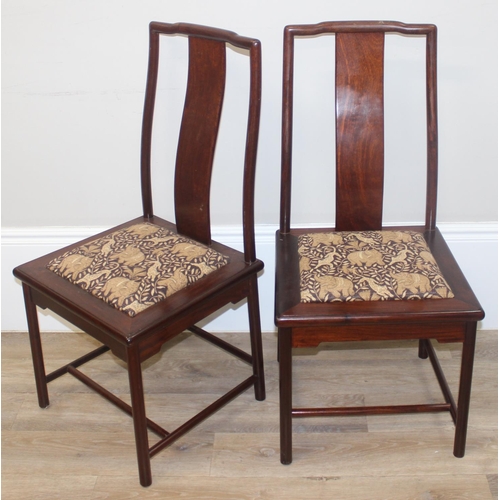 112 - A set of 10 (8 + 2 carvers) Chinese hardwood dining chairs with later animal fabric seats, each appr... 