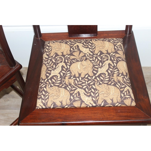 112 - A set of 10 (8 + 2 carvers) Chinese hardwood dining chairs with later animal fabric seats, each appr... 